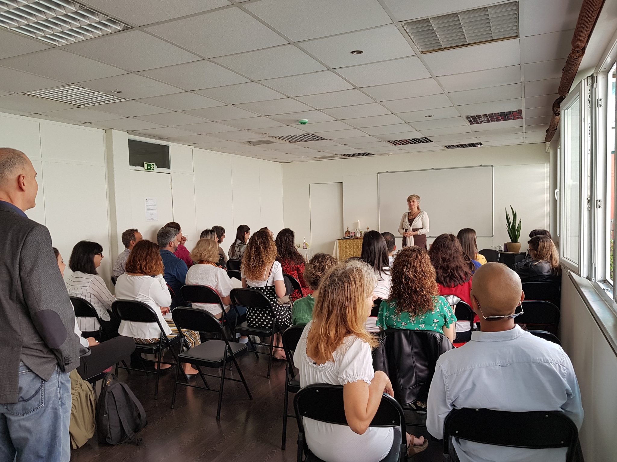 group of people sat down attending a space clearing and geomancy course 