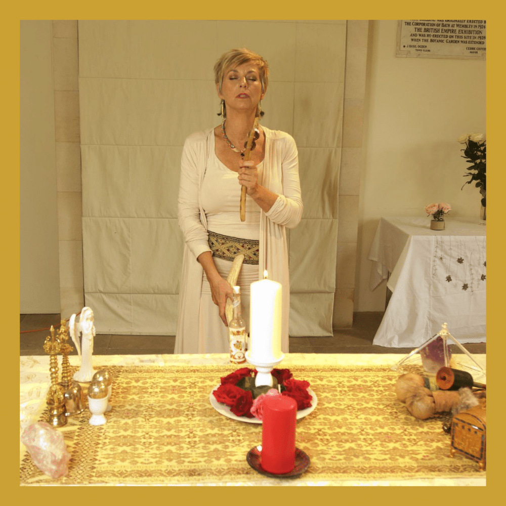 Sue Holmes in purple on her healing journey, holding a condor feather 