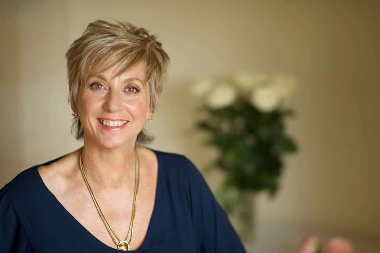 Mum's fav in blue without bra strap 2 Sue Holmes completing a healing session with someone lay down next to her