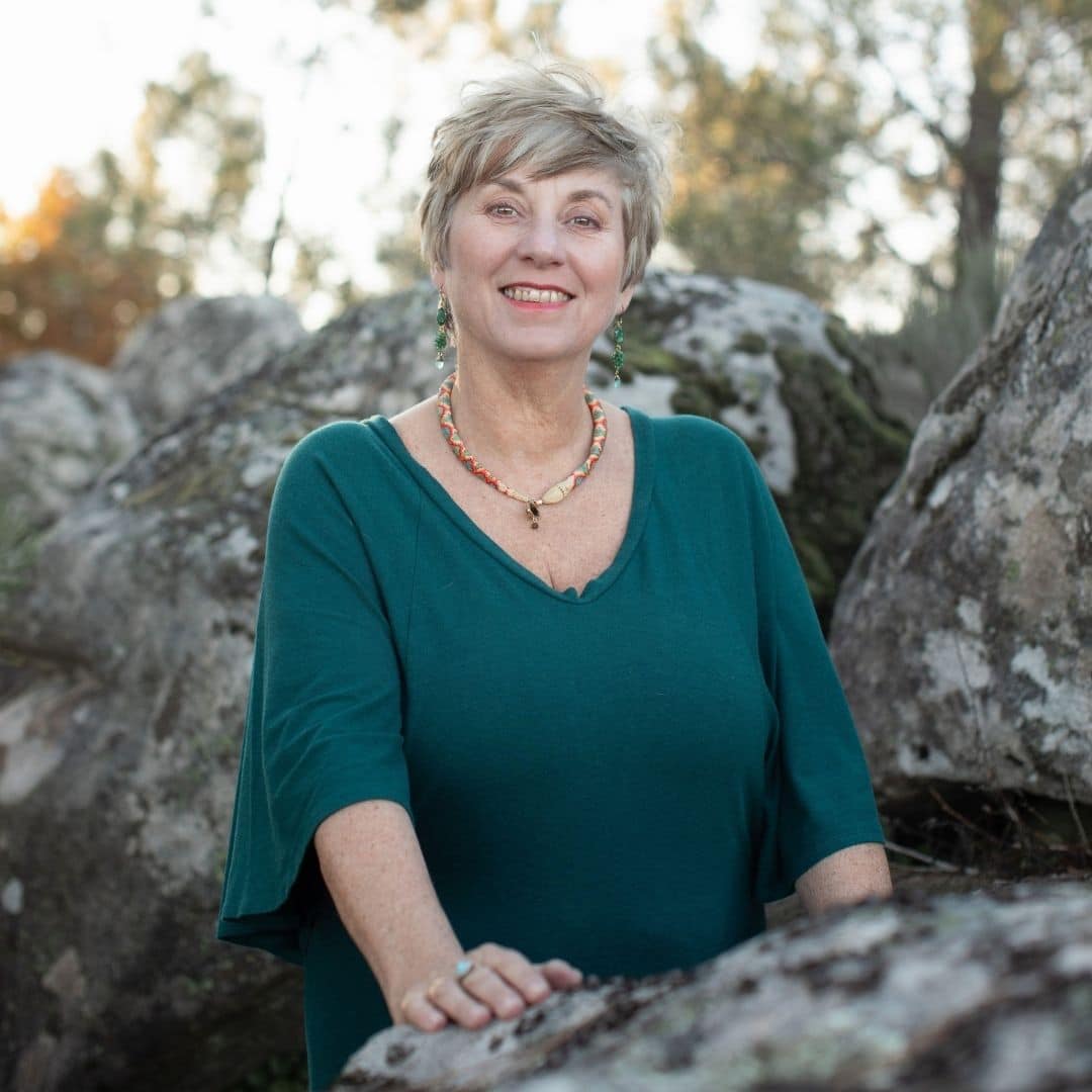 Sue Holmes completing a healing session with someone lay down next to her