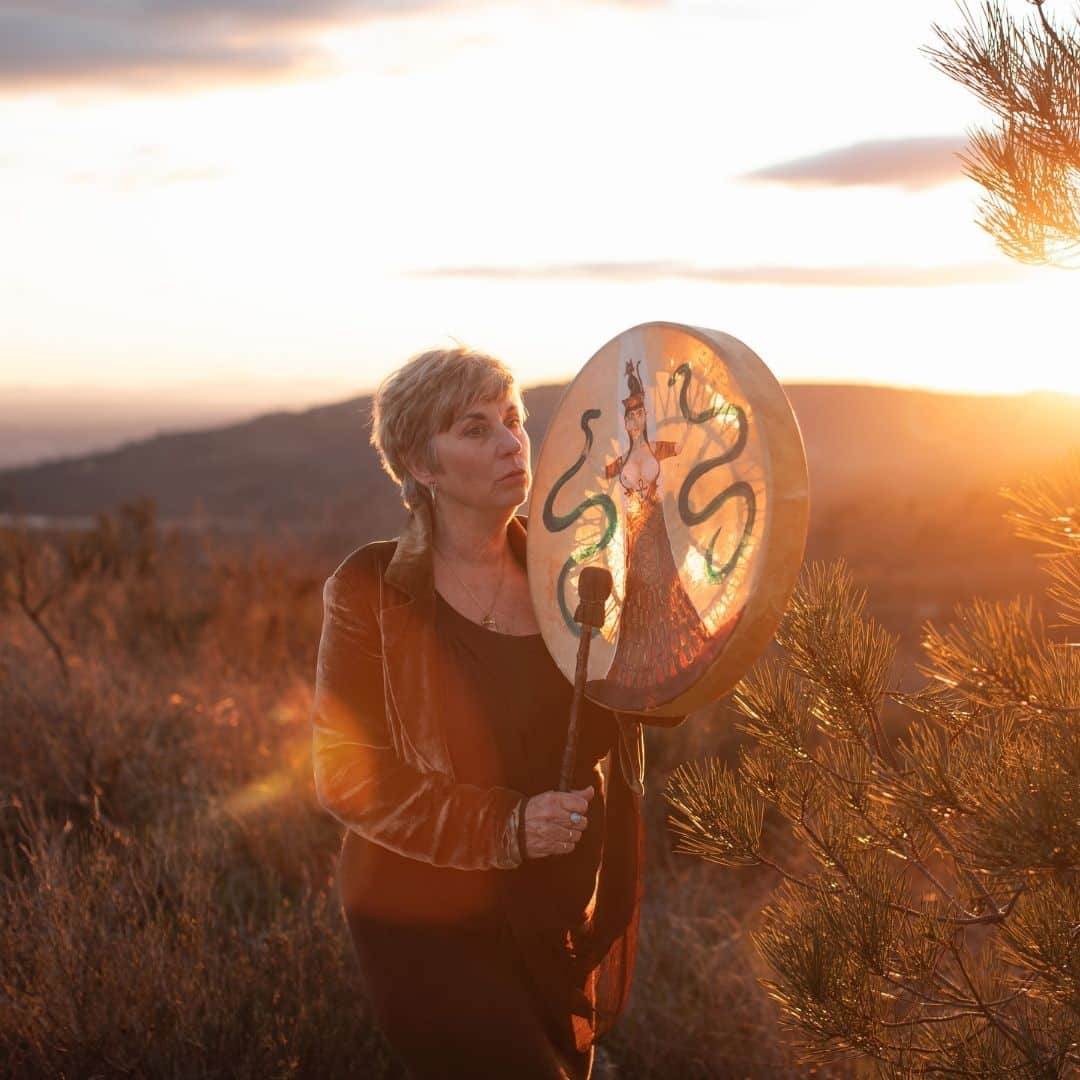 Sue Holmes completing a healing session with someone lay down next to her